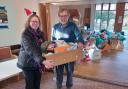 WI president Sheila Willson handing over the toy donations to Peter Harris from the toy bank.