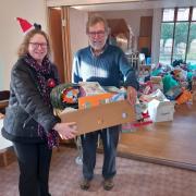 WI president Sheila Willson handing over the toy donations to Peter Harris from the toy bank.