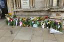 Floral tributes are being left outside Ely Cathedral.