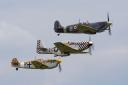 Spitfire MH434, Mustang TF51 'Contrary Mary' and a Hispano Bouchon in flight over IWM Duxford.
