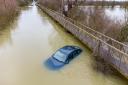 A car remains abandoned as water levels still rise at The Causeway Sutton Gault.. Monday 01 February 2021.