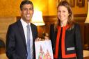 MP Lucy Frazer presents prime minister Rishi Sunak with a Christmas card designed by pupils in her South East Cambridgeshire constituency.