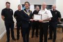 Soham's mayor Cllr David Woricker presents firefighters with the ‘Pride In Our Town Award’.