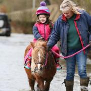 Emily (4) rides Angel the Pony with help from Nanna on Flooded Sutton Gault Road.
Cambridgeshire underwater as river levels continue to rise and Environment Agency issues flood alerts for the area.,
Sutton Gault, Ely
Wednesday 29 December 2021. 
Picture