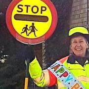 More 'lollipop' men and women are being asked to take on school crossing patrols by Cambridgeshire County Council during Road Safety Week. Pictured is lollipop lady Annette Palmer has retired from her duties after 10 years of service at The Weatheralls