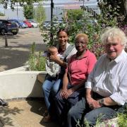 Newnham Street car park in Ely has recently had a transformation. Pictured using the new seating area on June 20 is Cllr Bill Hunt (R) and open spaces and facilities manager Spencer Clark (L) with mother and daughter Blessing Smith and Christy Buckingham