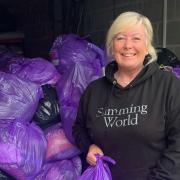 Sharon Heaps, who runs both Littleport and Swaffham Prior Slimming World Groups, is pictured with the 171 bags of pre-loved items that were donated to Cancer Research UK, raising over £5,000.