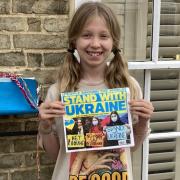 Rosa, 10, outside her home near the river in Ely making and selling bracelets to support Ukraine.