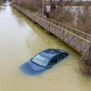 A car remains abandoned as water levels still rise at The Causeway Sutton Gault.. Monday 01 February 2021.