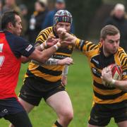 Ryan Clark fends off a Wisbech player for Ely Tigers.