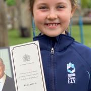 Eight-year-old Willow Barry with the thank you card she received from Her Majesty The Queen following Prince Philip's death.