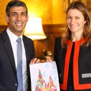 MP Lucy Frazer presents prime minister Rishi Sunak with a Christmas card designed by pupils in her South East Cambridgeshire constituency.