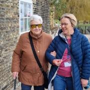 Sight loss charity Guide Dogs is looking for 'sighted guides' in Peterborough and Ely. Pictured is Linda from Ely being supported by her My Sighted Guide volunteer, Sarah.