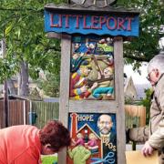 WI member Cynthia Leggat and husband Andy clean, touch-up the paintwork and varnish the village sign!