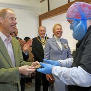 One of the Harry Specters chocolatiers gives HRH Prince Edward the chocolate bar he had made earlier during the visit.