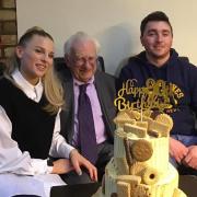 Martin Pate (centre) on his 90th birthday with his grandchildren Heidi and Angus