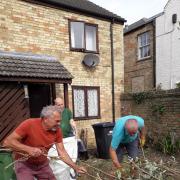 Volunteer gardening team lend a helping hand.