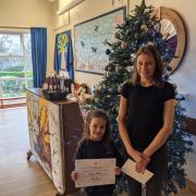 Year two pupil at Cheveley Primary School, Hanga Babos, was selected as the winner for her design which depicted a Christmas bike ride.