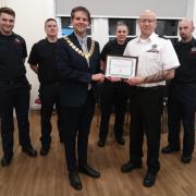 Soham's mayor Cllr David Woricker presents firefighters with the ‘Pride In Our Town Award’.