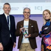 Paul Fox (centre) receiving his award from Professor Alice Roberts and Ben Long.