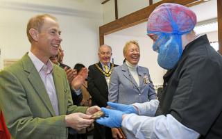 One of the Harry Specters chocolatiers gives HRH Prince Edward the chocolate bar he had made earlier during the visit.