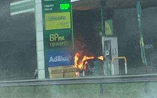 Cars are on fire and the petrol station has been  engulfed in smoke