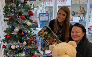 Mandy Watkins, Premier Travel Ely branch manager, and Lauren Raper travel consultant, with some of the new toys donated for Ely Toy Bank by customers.
